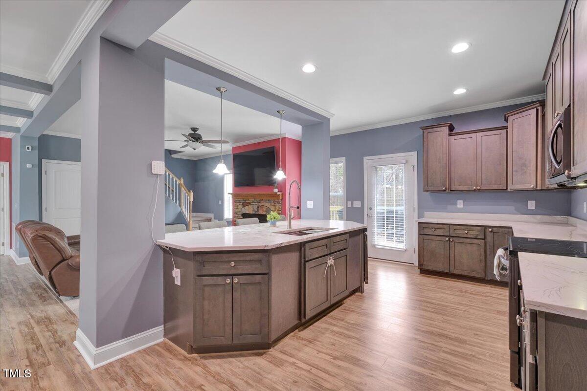 90 Ferncrest Court Roxboro, NC 27574 - Photo 17 of 45 a kitchen with stainless steel appliances granite countertop a sink stove and wooden floor