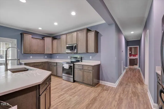 a kitchen with a sink stove and cabinets