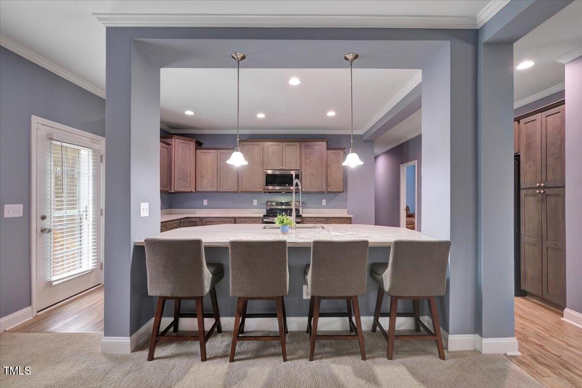 90 Ferncrest Court Roxboro, NC 27574 - Photo 21 of 45 a kitchen with stainless steel appliances a dining table chairs and wooden floor