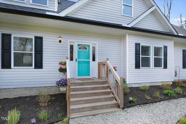 a front view of a house with a garden