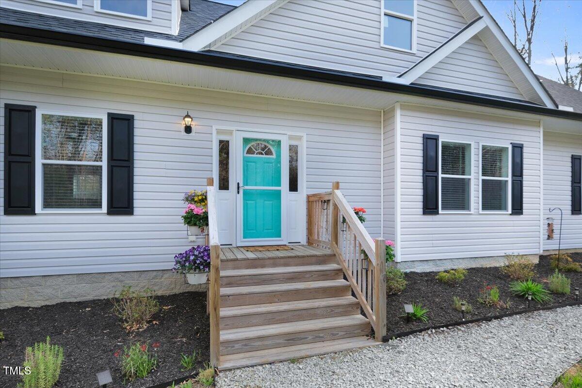 90 Ferncrest Court Roxboro, NC 27574 - Photo 3 of 45 a front view of a house with a garden
