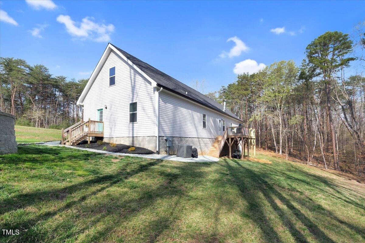 90 Ferncrest Court Roxboro, NC 27574 - Photo 37 of 45 a view of a house with backyard and sitting area