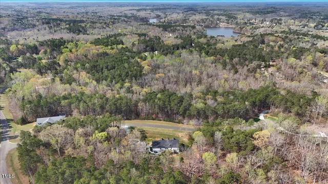 an aerial view of a houses with a yard