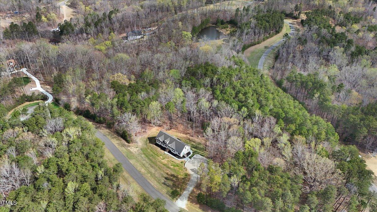 90 Ferncrest Court Roxboro, NC 27574 - Photo 44 of 45 a view of a yard with plants and a bench