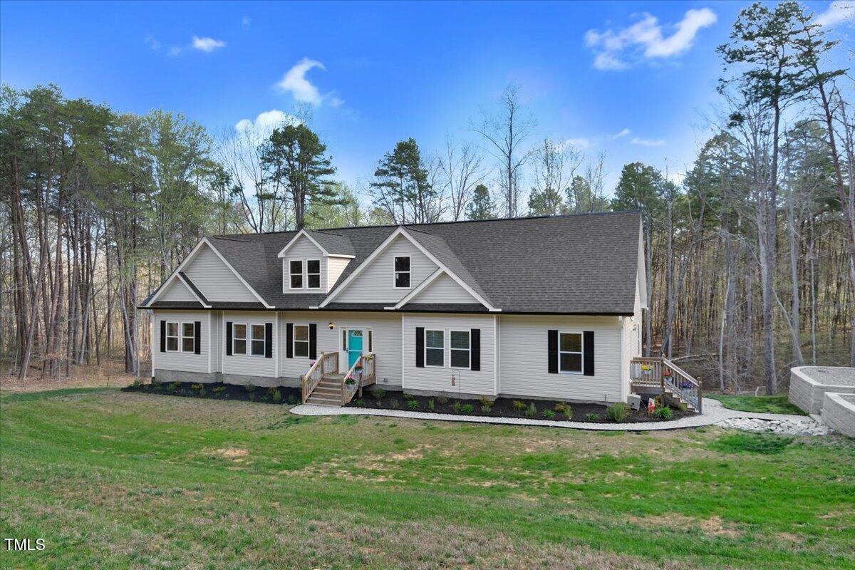 90 Ferncrest Court Roxboro, NC 27574 - Photo 7 of 45 a front view of a house with a garden and trees