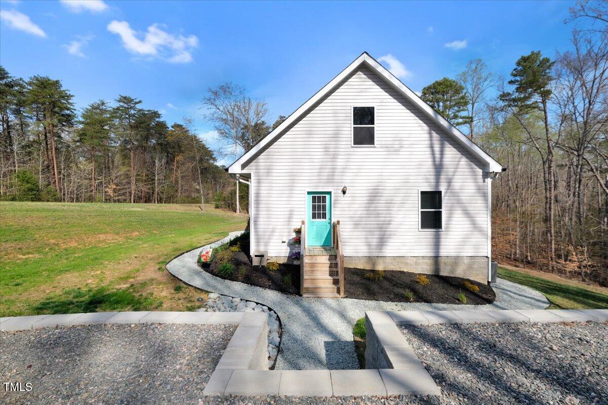 90 Ferncrest Court Roxboro, NC 27574 - Photo 9 of 45 a view of a white house with a yard