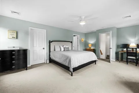 a bedroom with a bed and dresser
