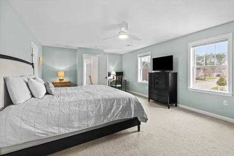 a bedroom with a large bed and a tv