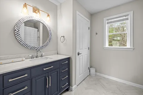 a bathroom with a sink and a mirror