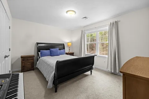 a bedroom with a bed and window
