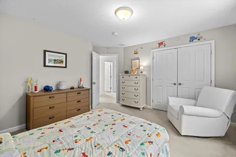 a bedroom with a bed and a couch