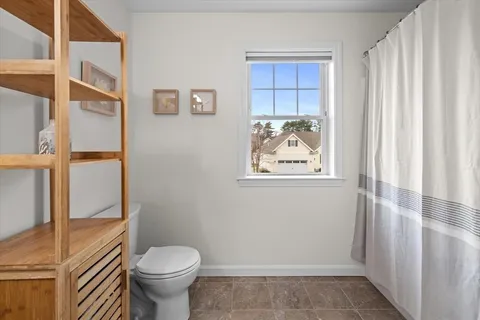 a bathroom with a toilet and a shower