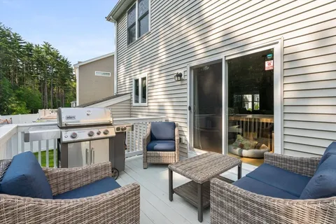 a view of a chairs and table in the back yard of the house