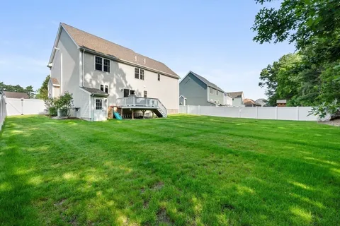 a view of a house with a yard and sitting area
