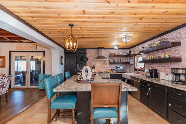 a bedroom with a bed and a table in it with wooden floor