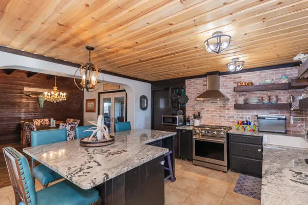 a bathroom with a granite countertop sink a mirror and shower