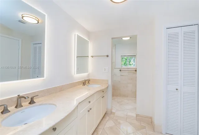 a bathroom with a double vanity sink and mirror