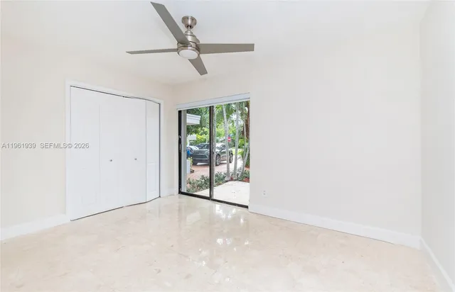 a view of a livingroom with a ceiling fan and window