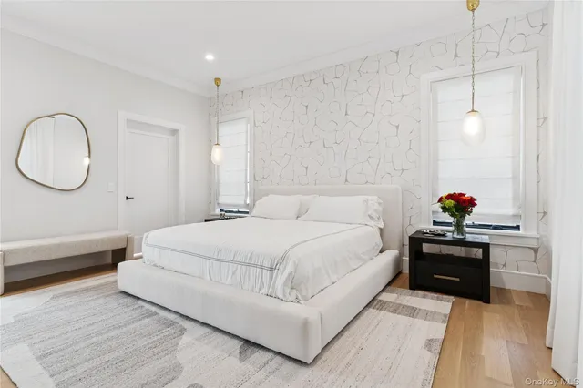 a bedroom with a bed and a chandelier