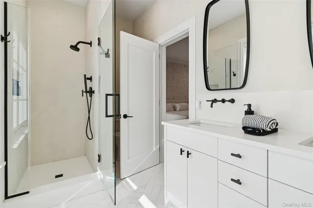 a bathroom with a shower sink and mirror
