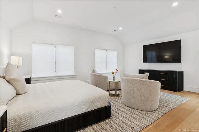 a bedroom with a bed and a flat screen television