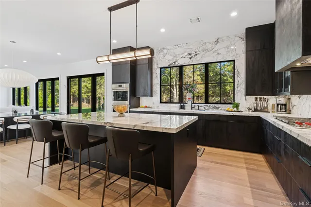 a kitchen with stainless steel appliances granite countertop a sink and a stove