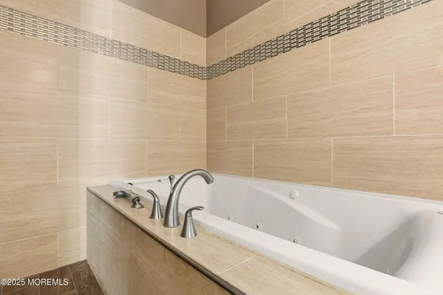 a bathroom with a bathtub and shower