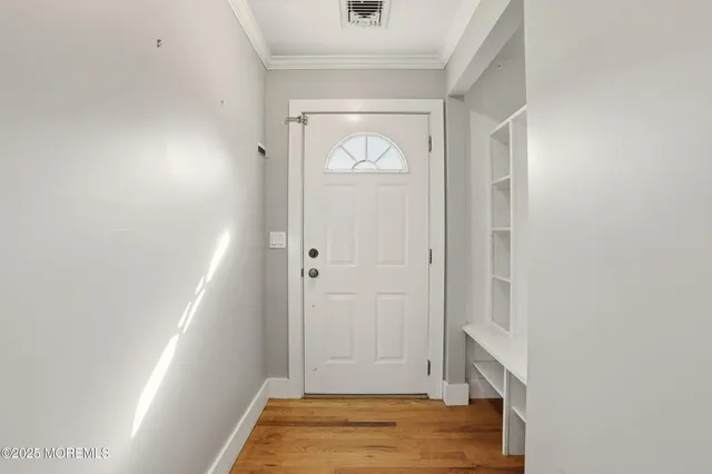 a view of front door with wooden floor