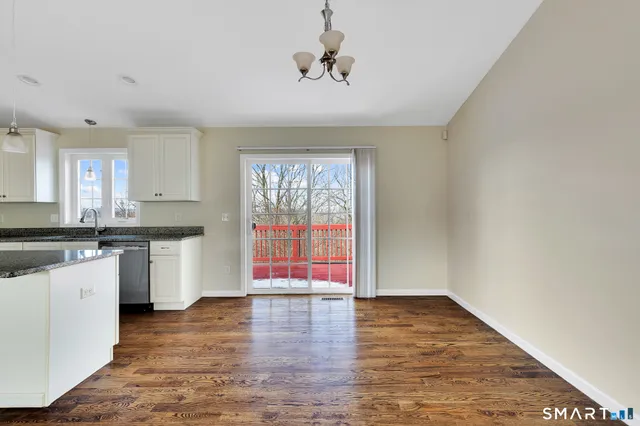 a kitchen with a wooden floor and a window
