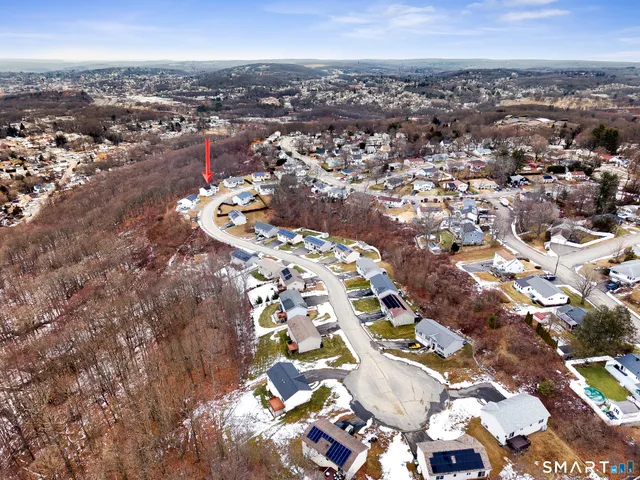 an aerial view of a house with swimming pool and lake view