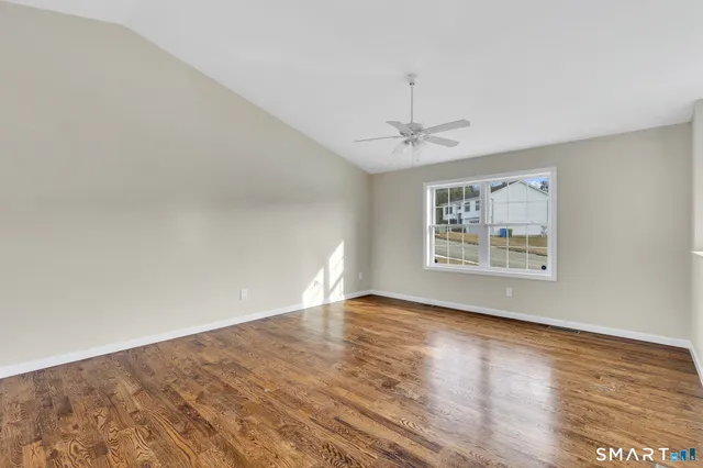 wooden floor in an empty room with a window