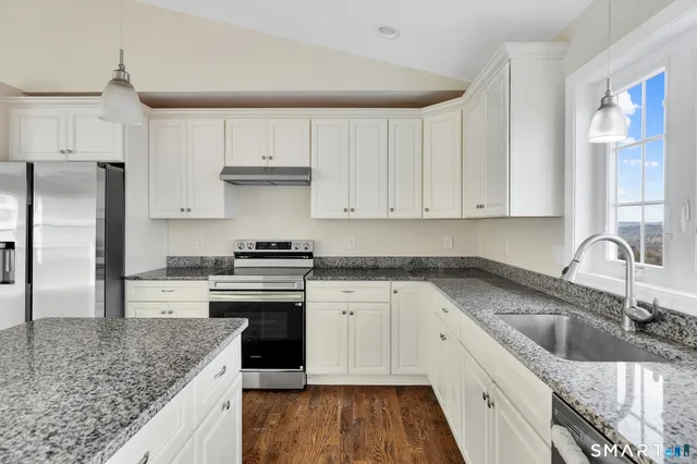 a kitchen with a sink stove and refrigerator