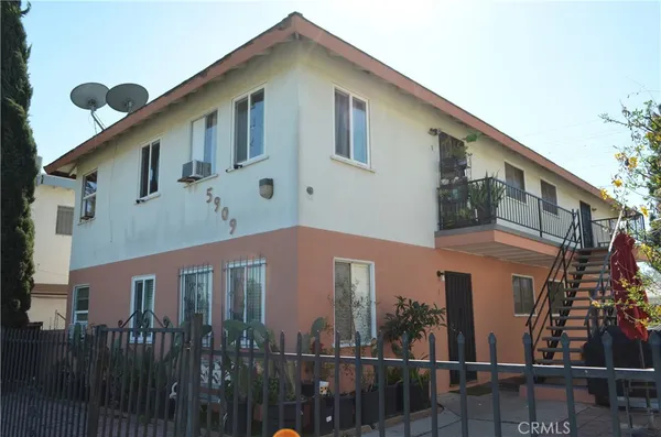 a front view of a house with glass windows and a small yard