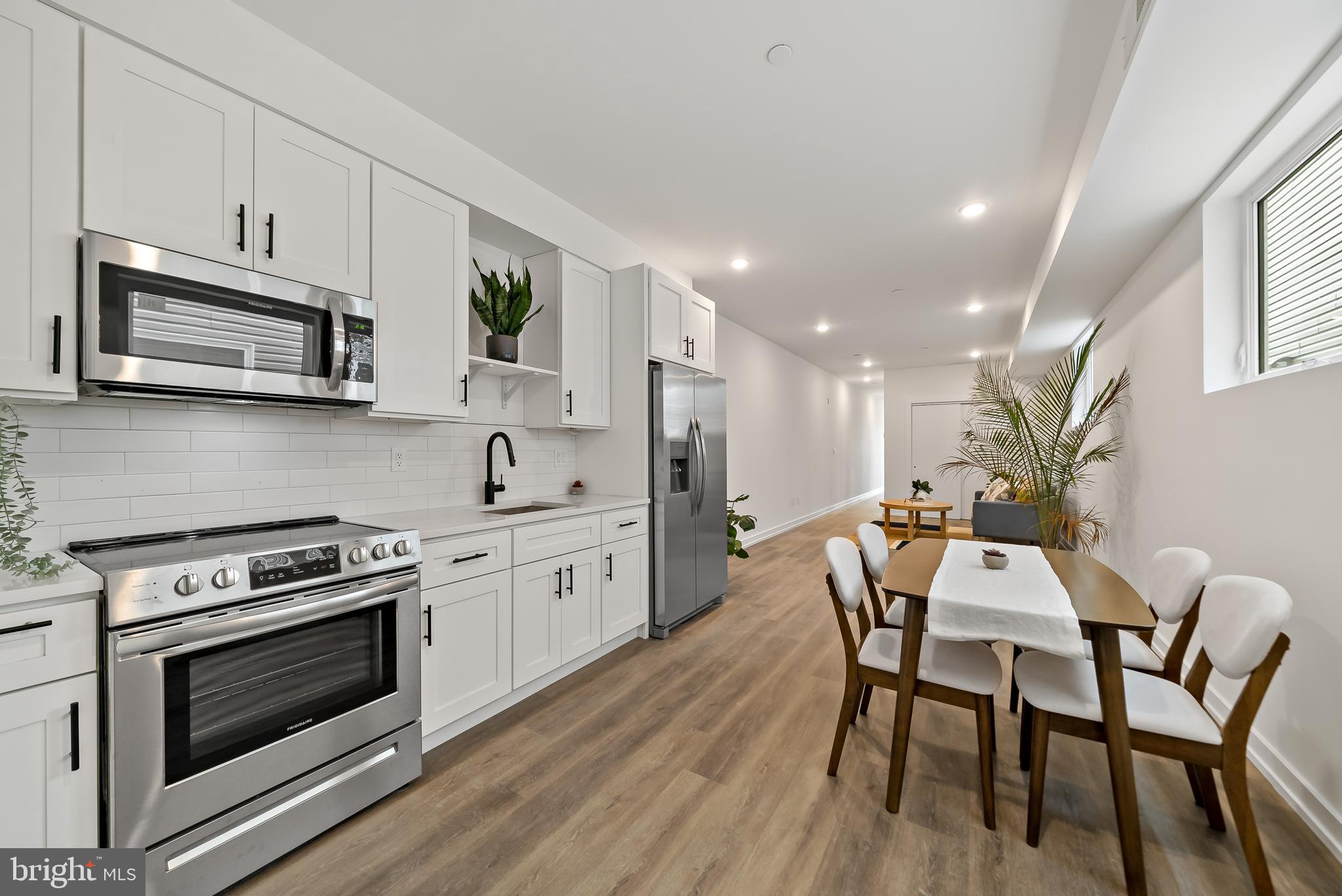 3845 North Broad Street, Unit 3F Philadelphia, PA 19140 - Photo 1 of 19 a kitchen with stainless steel appliances a stove a sink a microwave a stove and white cabinets