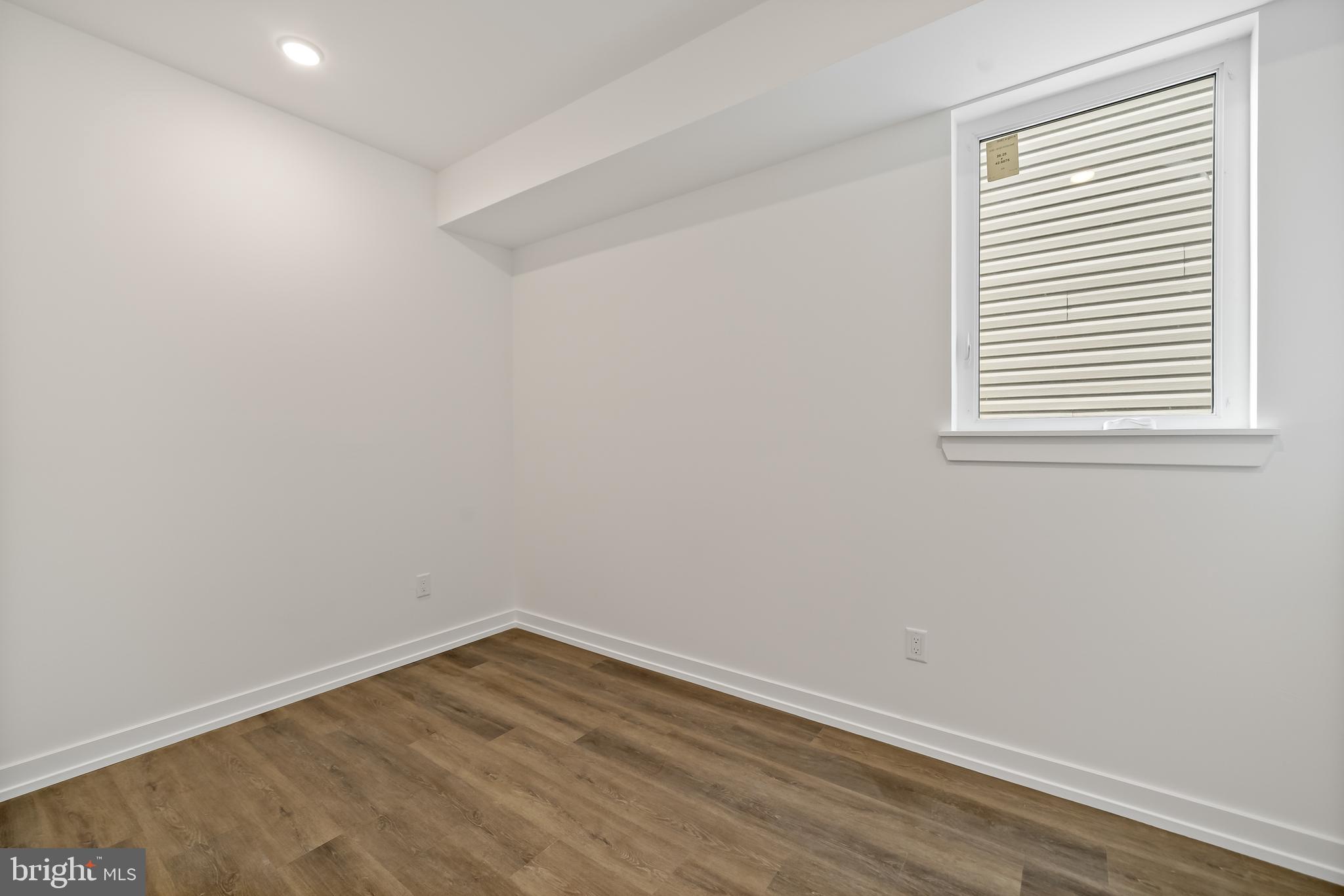 3845 North Broad Street, Unit 3F Philadelphia, PA 19140 - Photo 14 of 19 wooden floor in an empty room with a window
