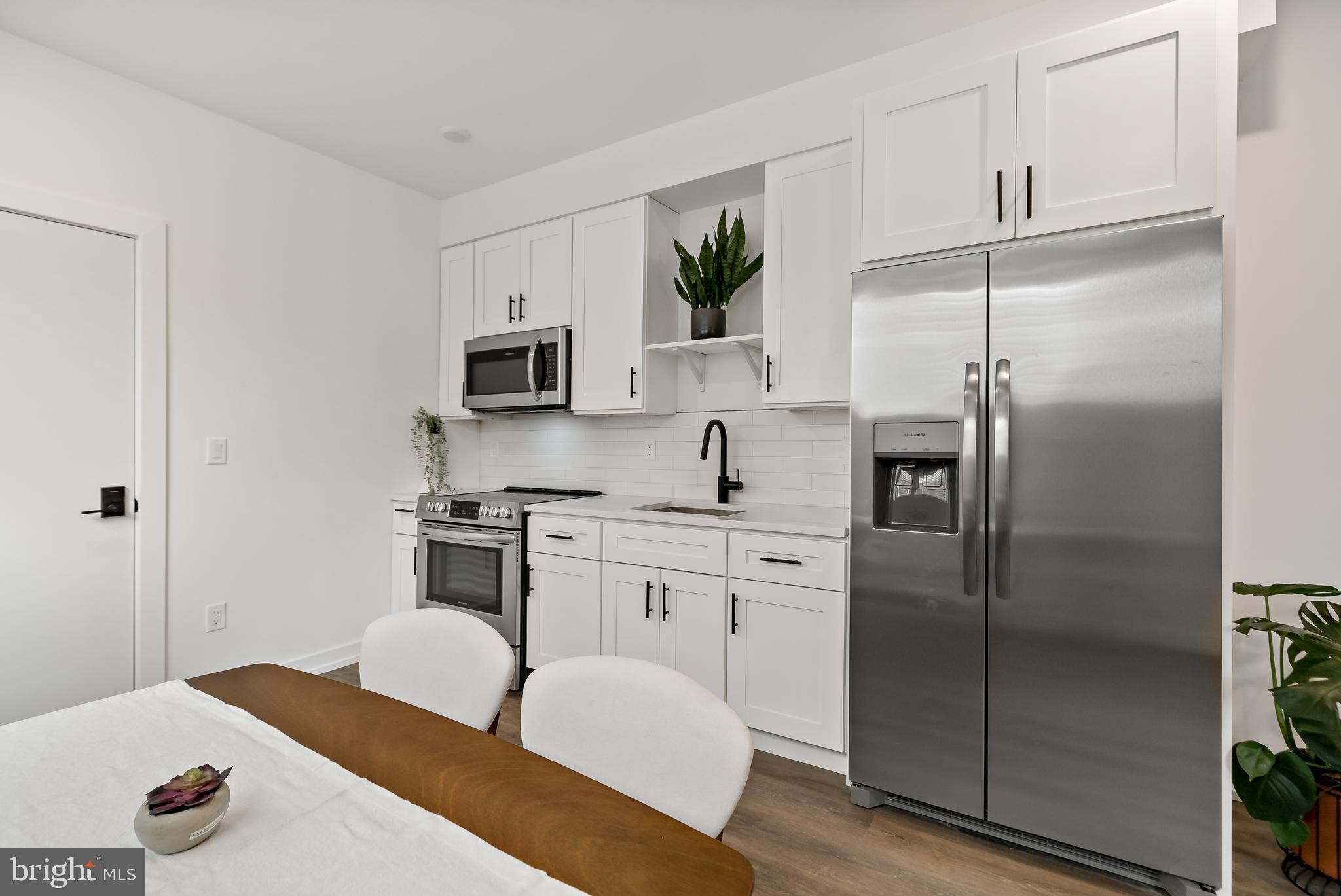 3845 North Broad Street, Unit 3F Philadelphia, PA 19140 - Photo 6 of 19 a kitchen with stainless steel appliances granite countertop a refrigerator sink and stove
