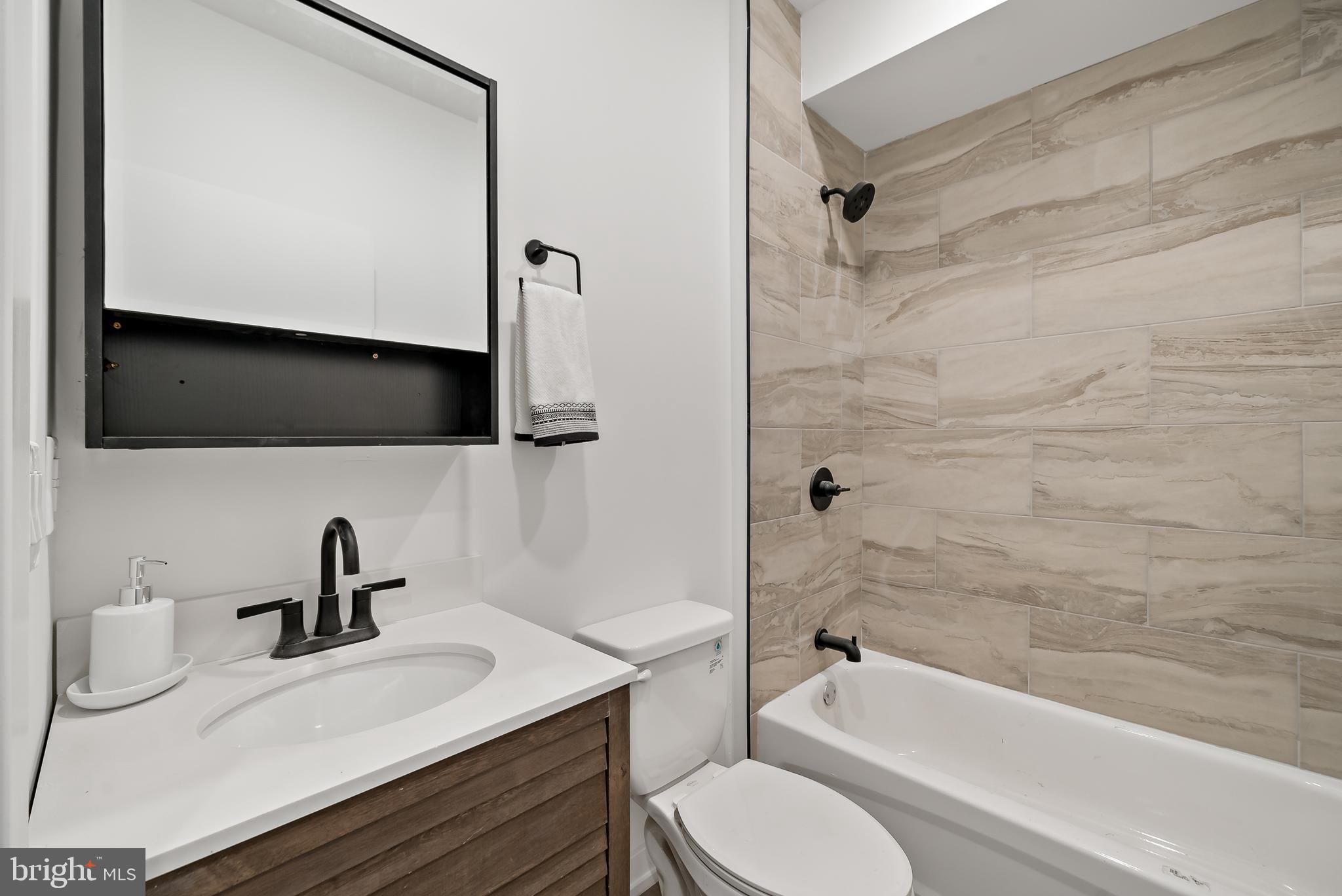 3845 North Broad Street, Unit 3F Philadelphia, PA 19140 - Photo 10 of 19 a bathroom with a sink a toilet and bathtub