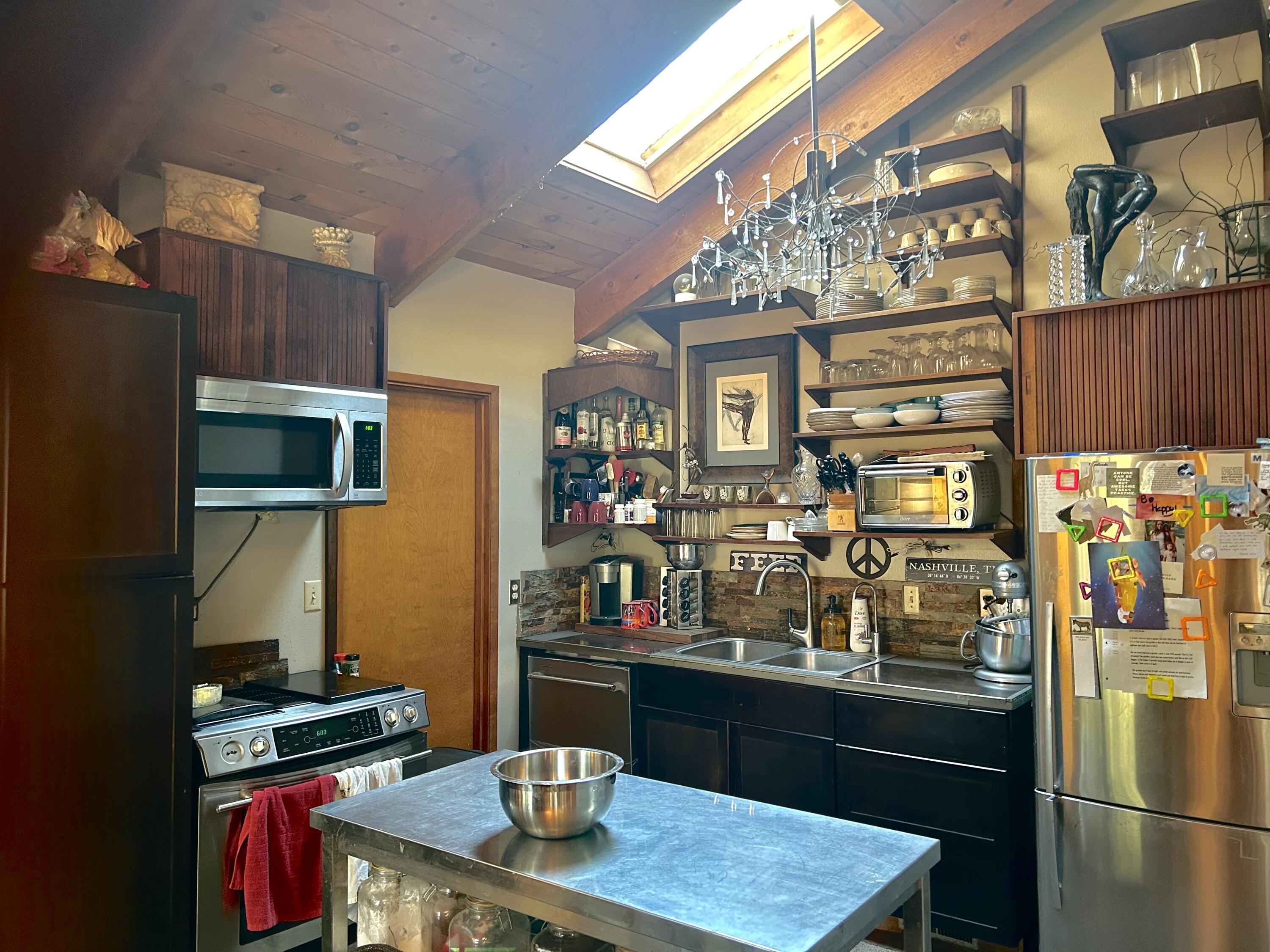 68964 Graham Court Sisters, OR 97759 - Photo 10 of 28 a kitchen with stainless steel appliances granite countertop a refrigerator and a stove