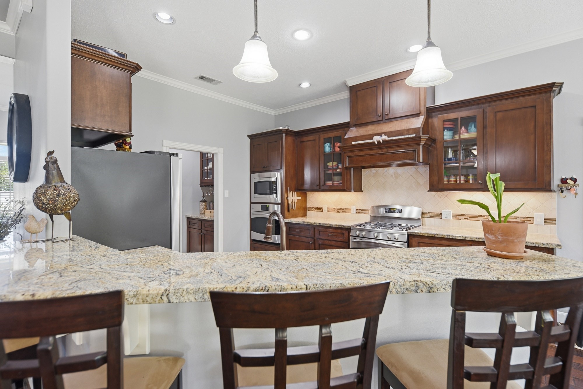 1205 Pecan Glen Road Brenham, TX 77833 - Photo 13 of 40 The kitchen with breakfast bar and open sightlines to the rest of the living area