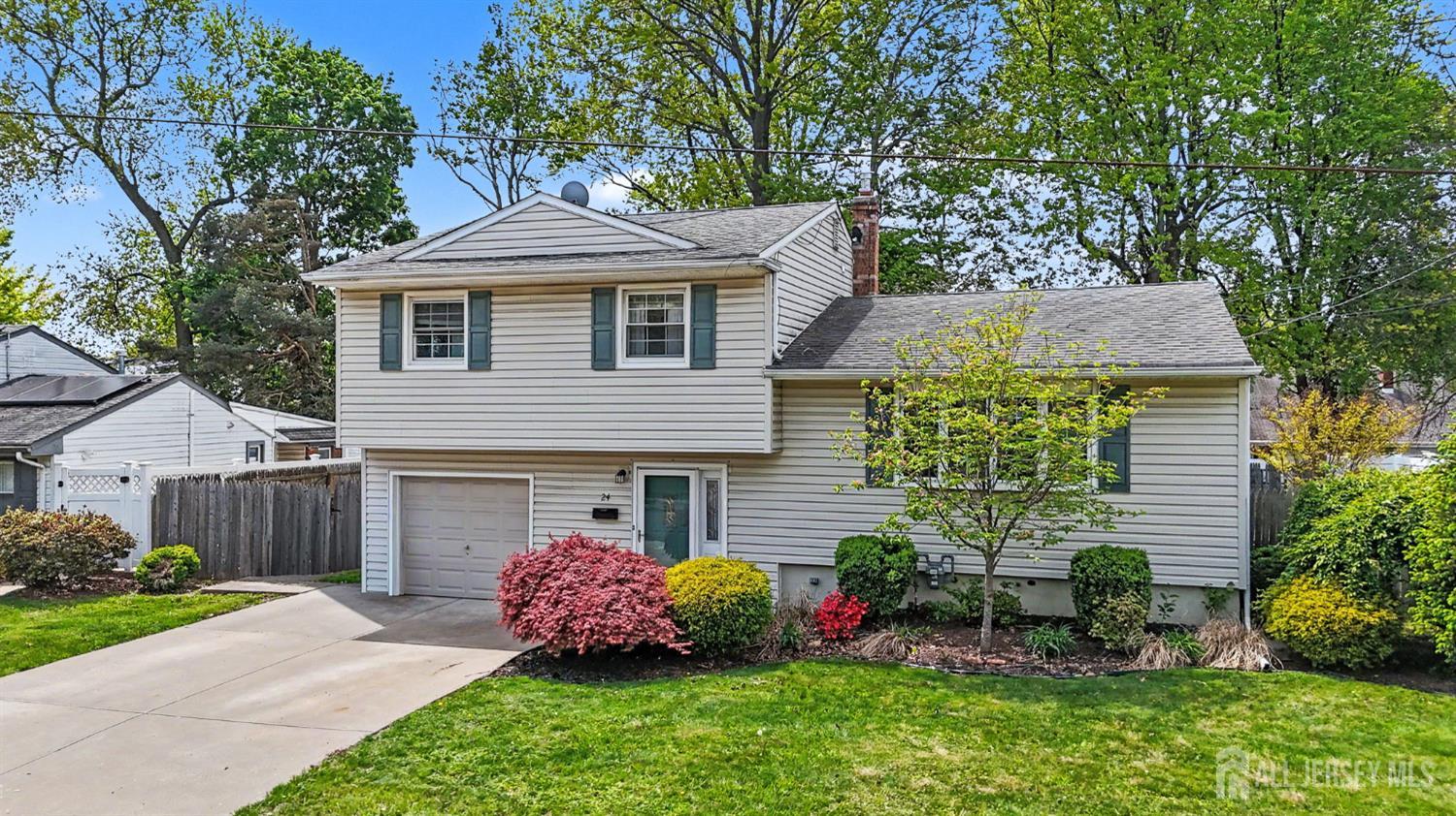 24 Moryan Road Edison, NJ 08817 - Photo 1 of 33 a front view of a house with a garden