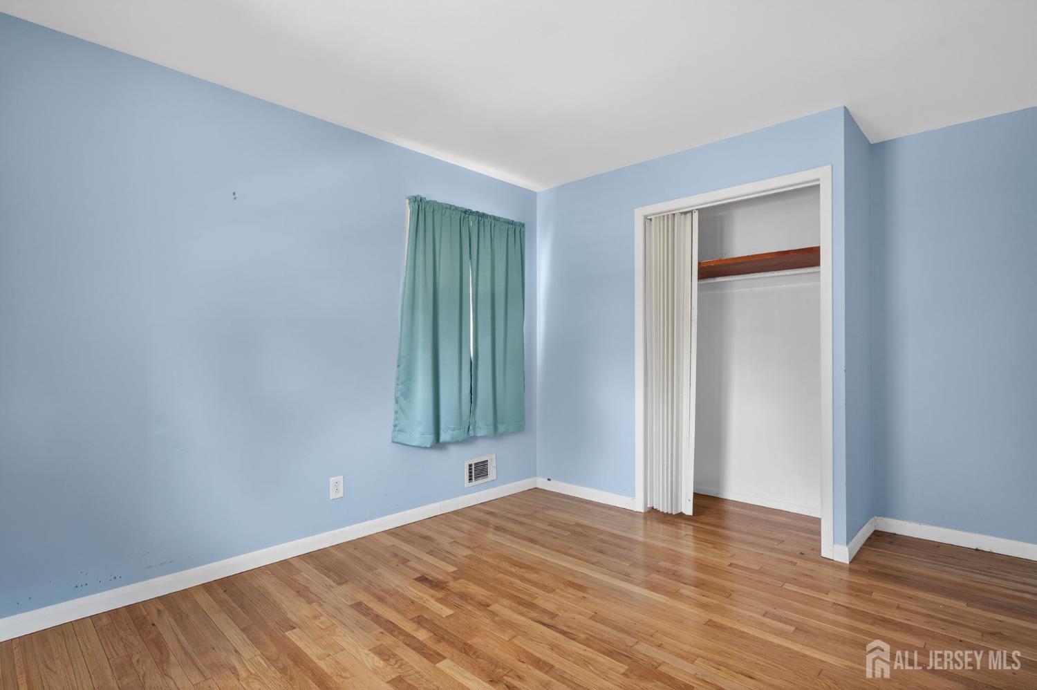 24 Moryan Road Edison, NJ 08817 - Photo 11 of 33 a view of an empty room with wooden floor and a window
