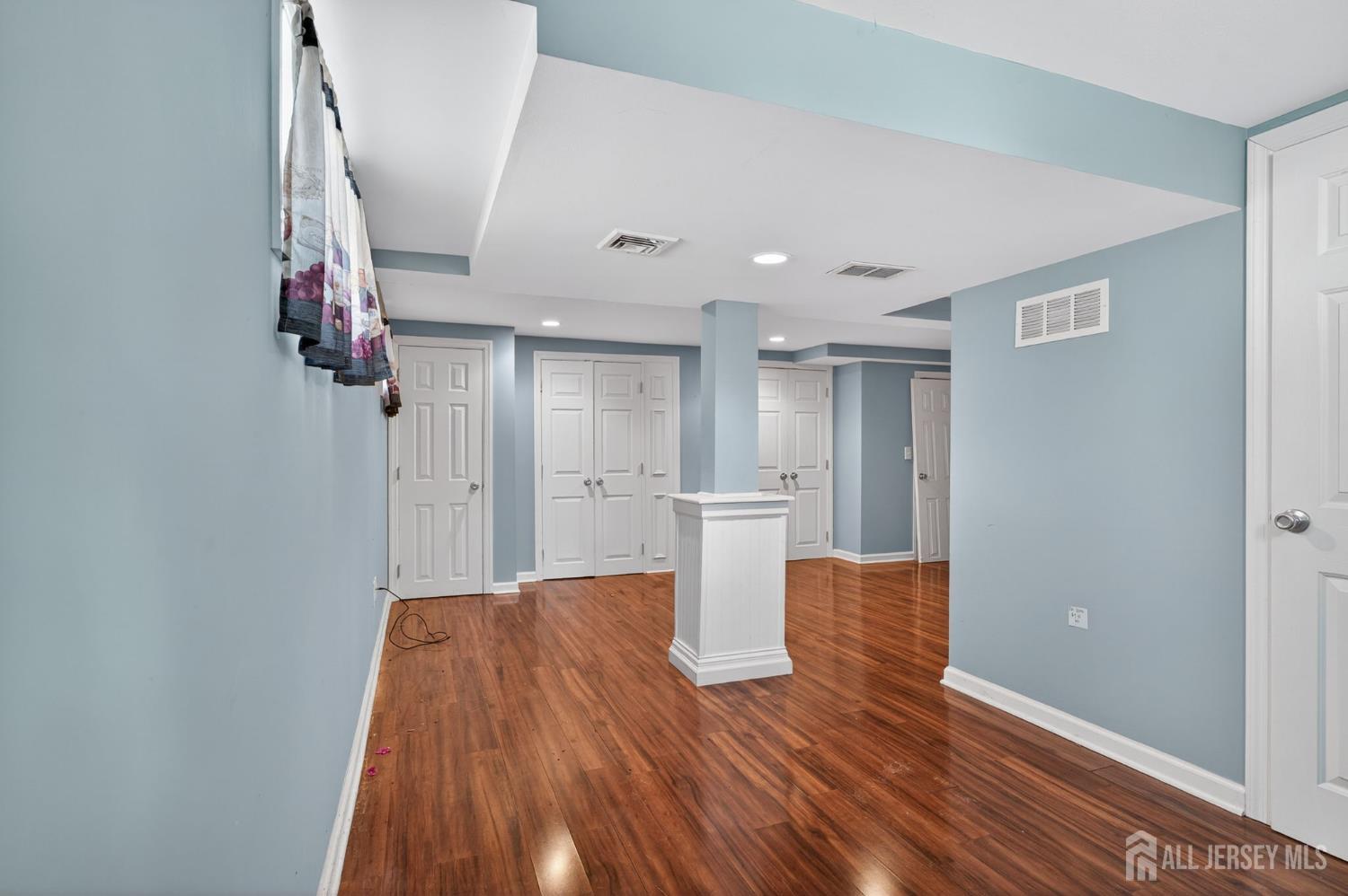 24 Moryan Road Edison, NJ 08817 - Photo 20 of 33 a view of kitchen and empty room with wooden floor