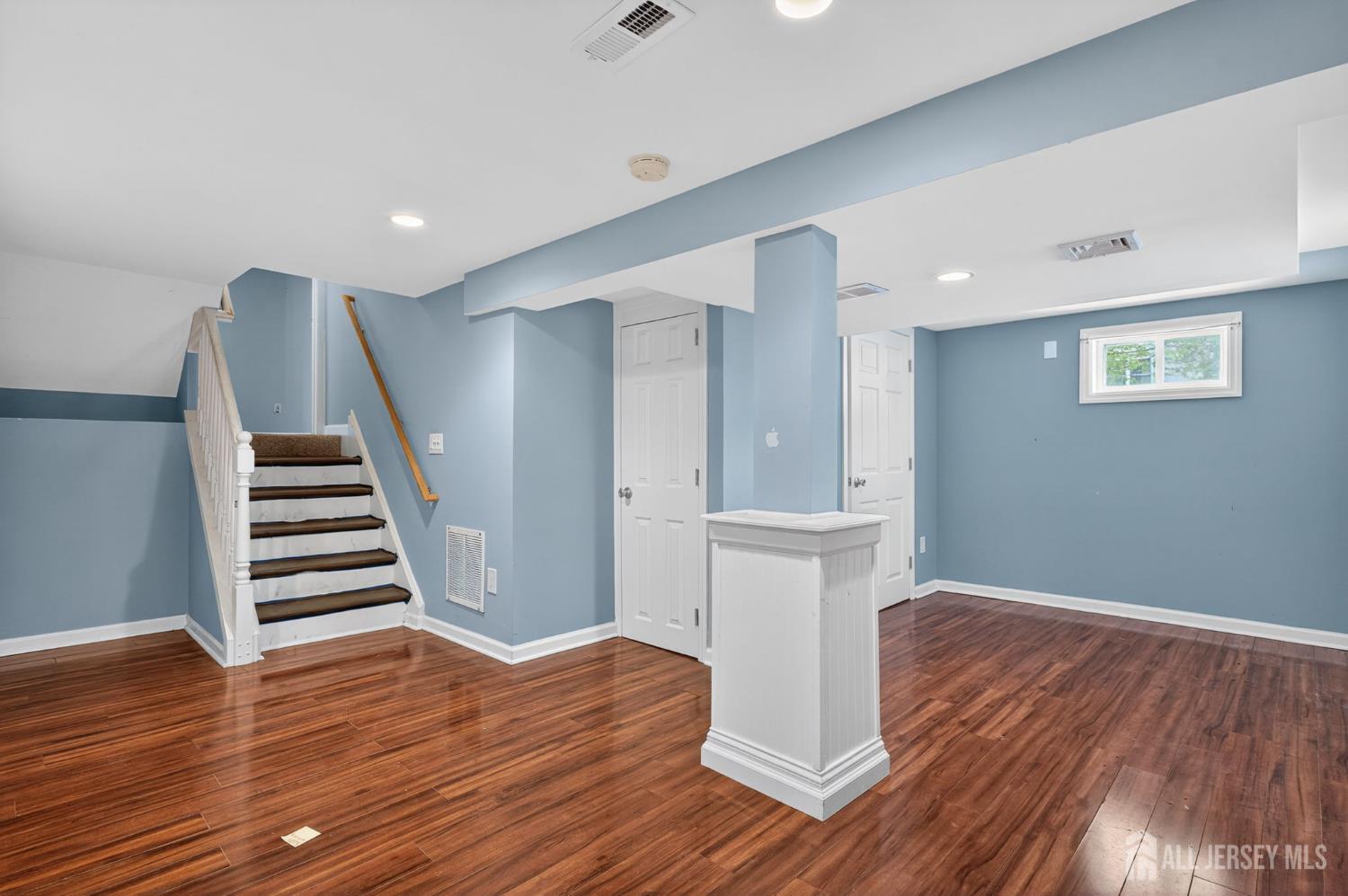 24 Moryan Road Edison, NJ 08817 - Photo 21 of 33 a view of hallway with stairs and wooden floor