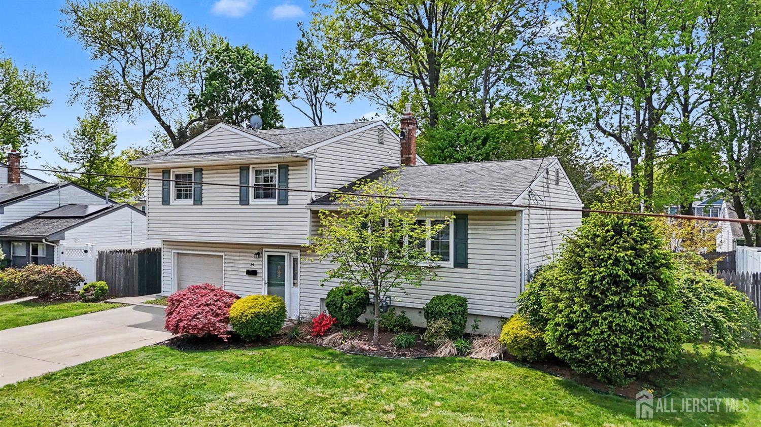 24 Moryan Road Edison, NJ 08817 - Photo 25 of 33 a front view of a house with a garden and plants