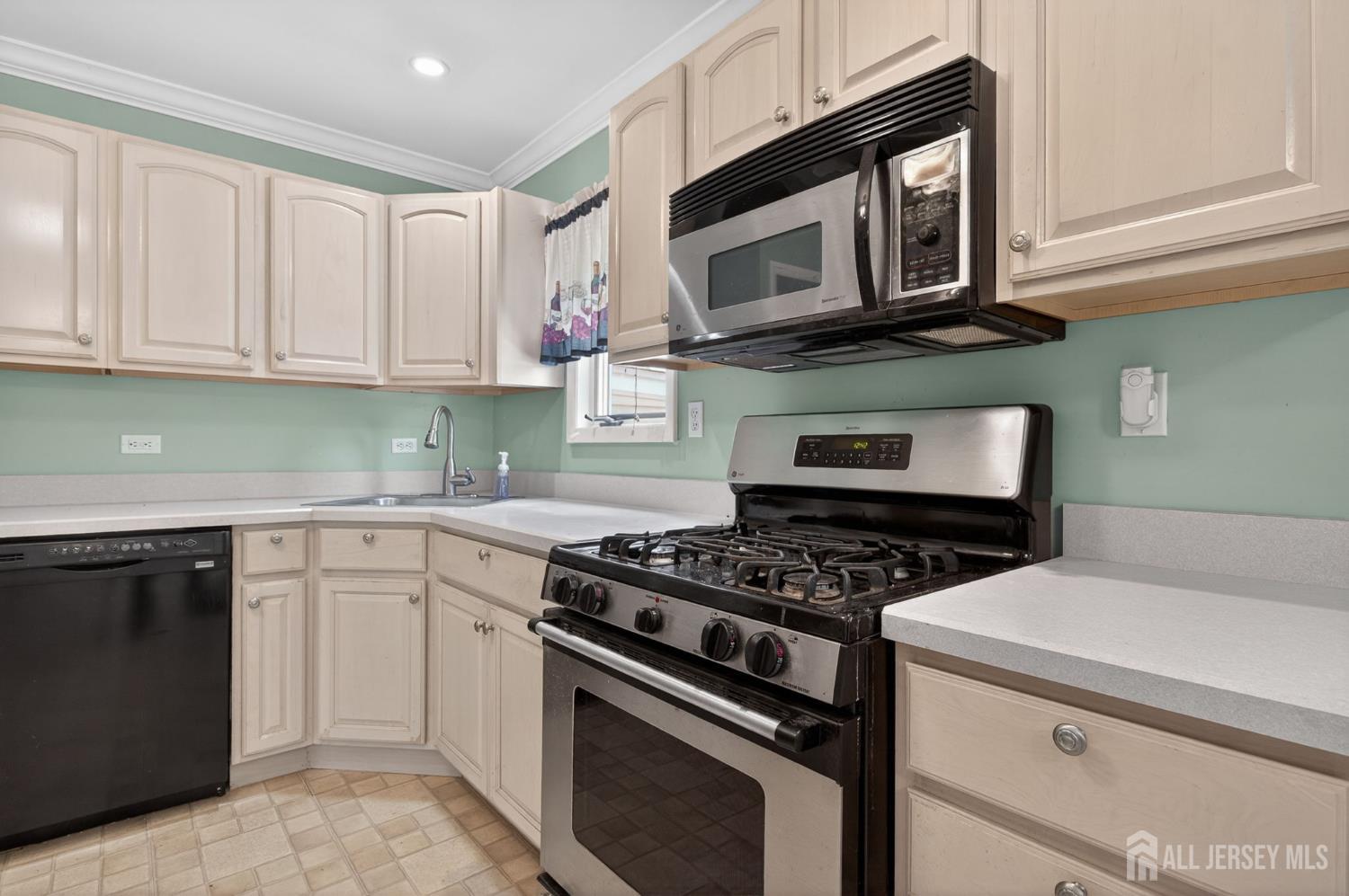 24 Moryan Road Edison, NJ 08817 - Photo 7 of 33 a kitchen with cabinets stainless steel appliances and a sink