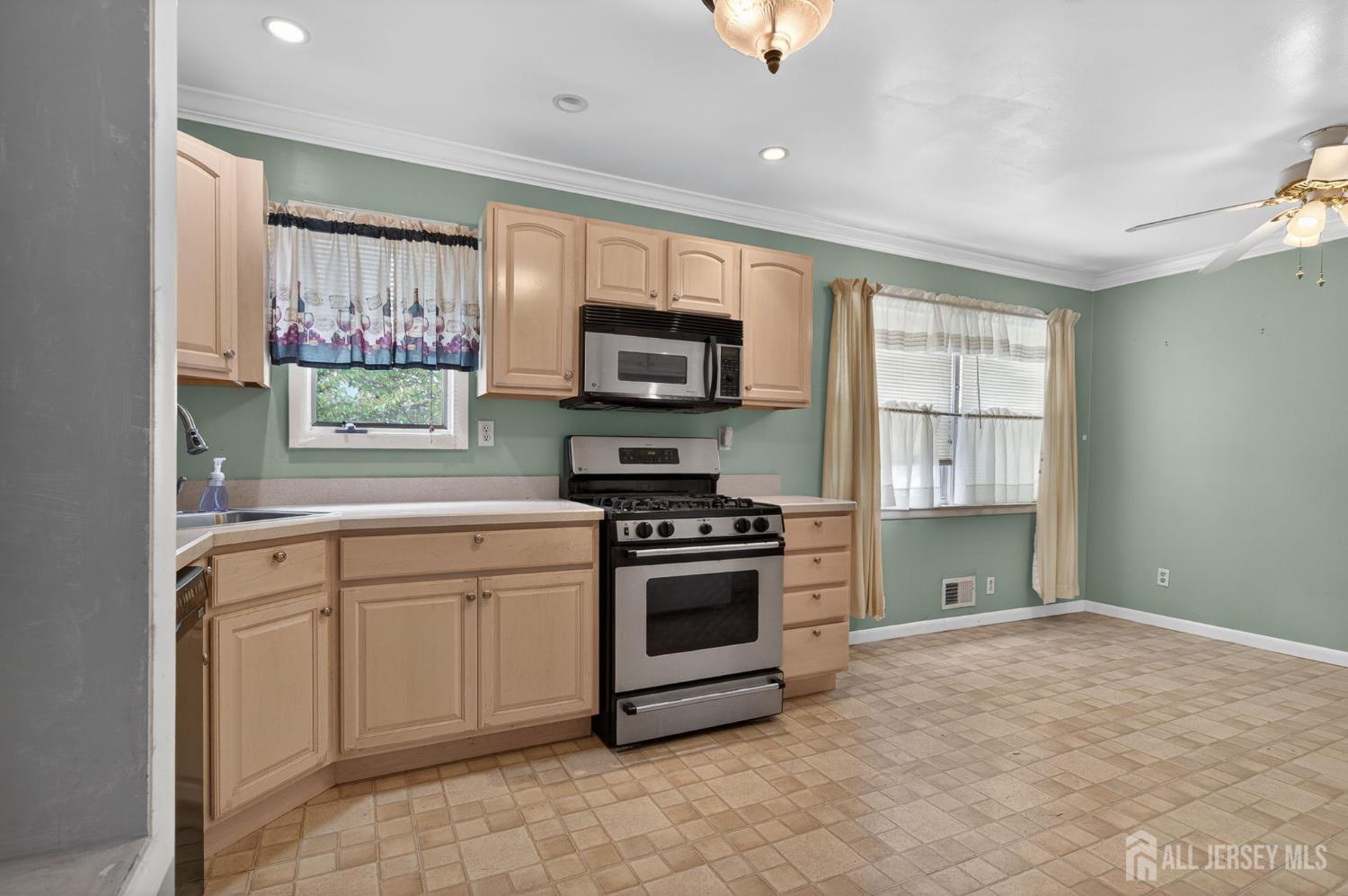 24 Moryan Road Edison, NJ 08817 - Photo 9 of 33 a kitchen with a stove a sink and a microwave