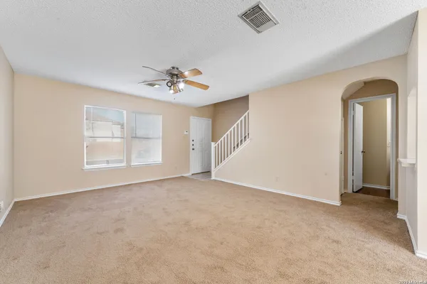 an empty room with windows and closet