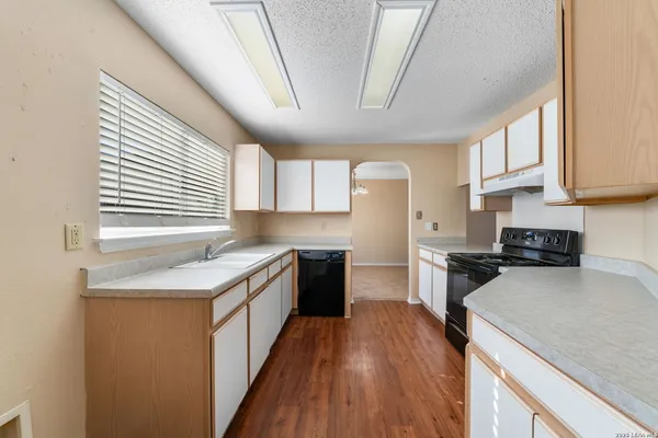 a kitchen with a stove a sink and a refrigerator