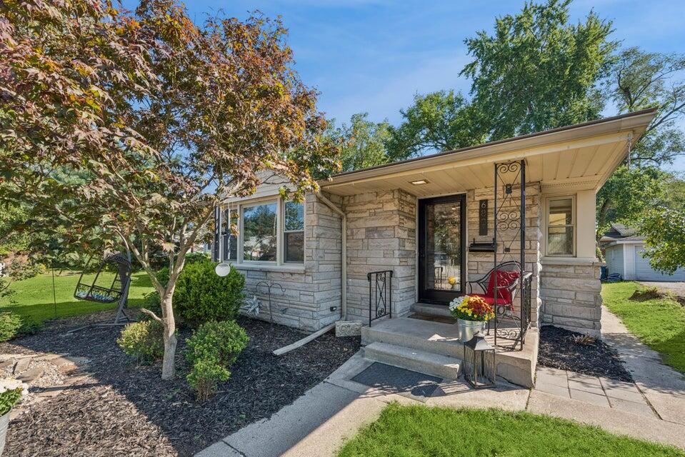 a view of a chair and table in backyard of the house