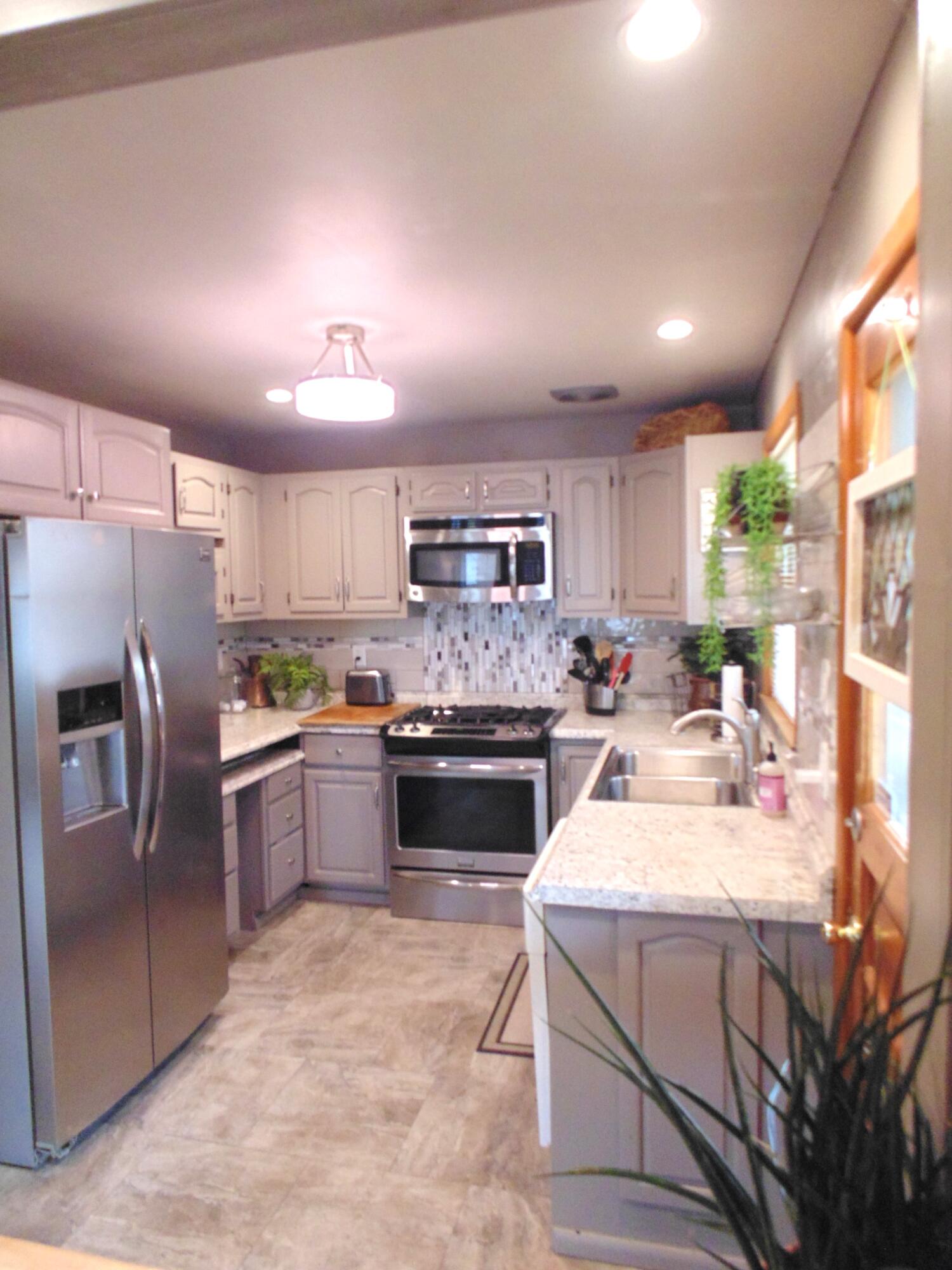6801 Forest Avenue Gary, IN 46403 - Photo 11 of 23 a large kitchen with a large counter top stainless steel appliances and cabinets